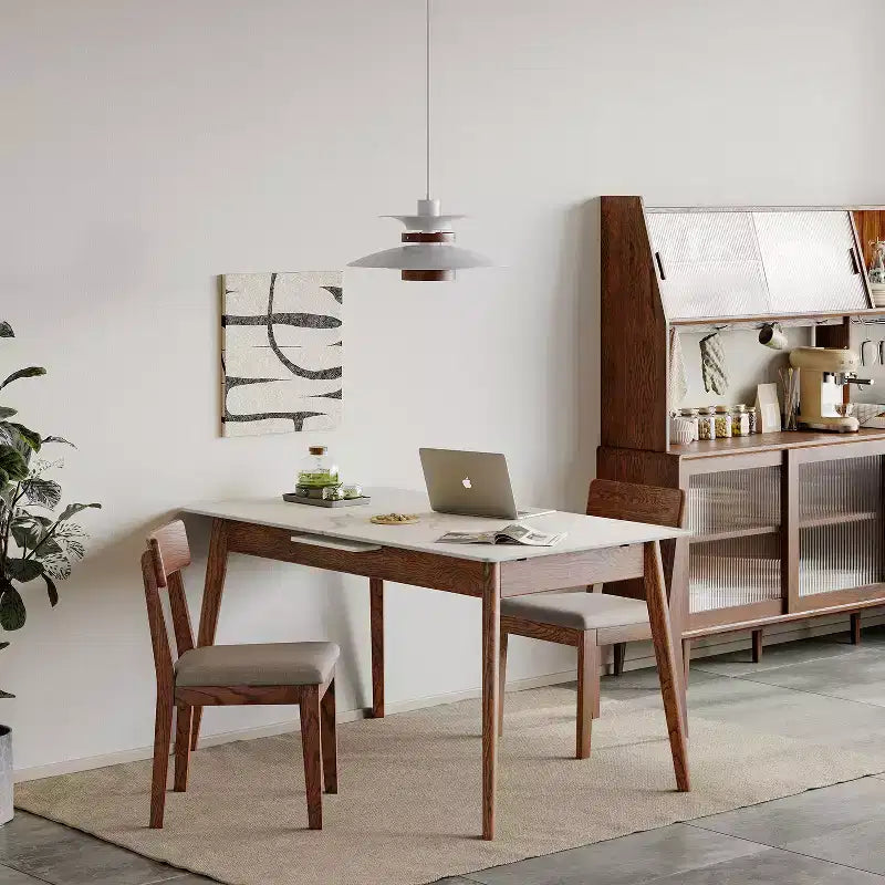 Modern dining area with wooden table, chairs, and a sideboard.